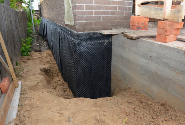 Happy homeowners after waterproofing job in Farmer
